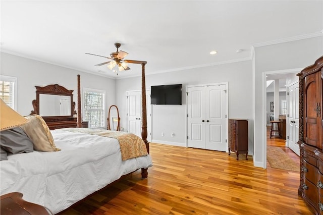 bedroom featuring ceiling fan, crown molding, and light wood-type flooring