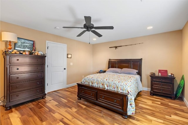 bedroom with ceiling fan and light hardwood / wood-style flooring