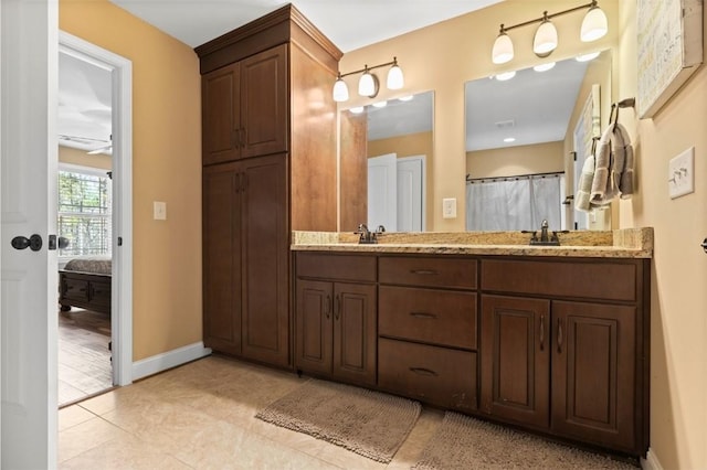 bathroom featuring curtained shower, tile patterned flooring, and vanity