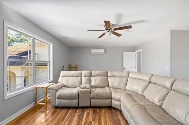 living room featuring wood-type flooring, a wall unit AC, and ceiling fan