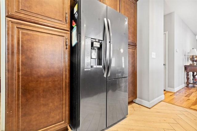 kitchen featuring stainless steel fridge and light wood-type flooring