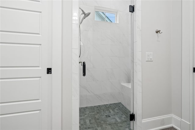 bathroom featuring a shower with shower door