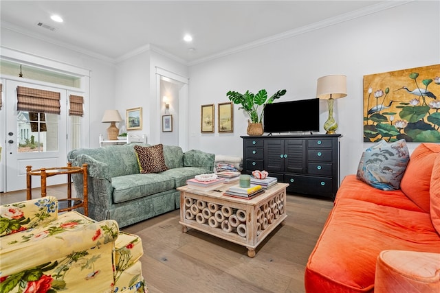 living room featuring hardwood / wood-style flooring and ornamental molding