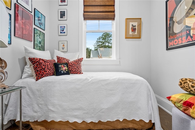 bedroom with hardwood / wood-style flooring