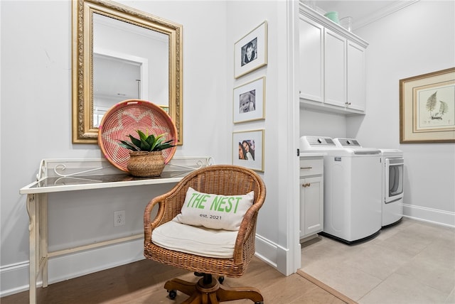 laundry area featuring cabinets, independent washer and dryer, crown molding, and light tile patterned floors