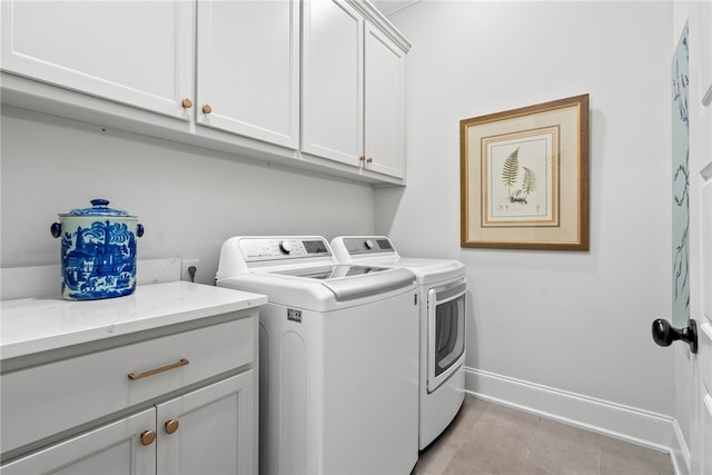 washroom with cabinets and independent washer and dryer