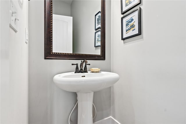 bathroom with baseboards and a sink