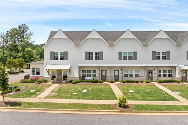 view of property featuring a front lawn