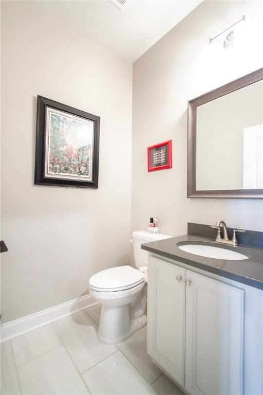 bathroom with tile patterned floors, vanity, and toilet