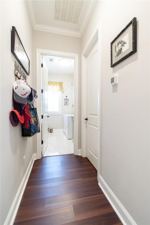 hall with crown molding and dark hardwood / wood-style floors