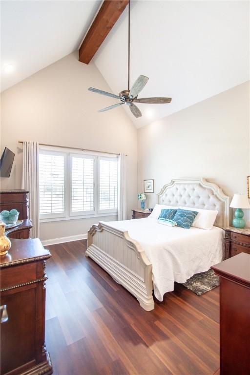 bedroom with beam ceiling, high vaulted ceiling, ceiling fan, and dark wood-type flooring