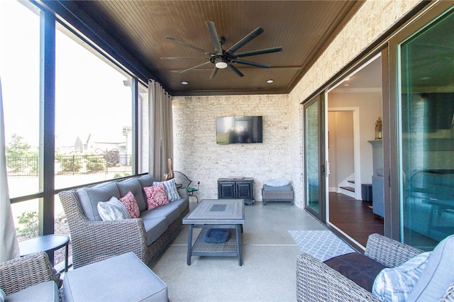 sunroom featuring ceiling fan and wood ceiling