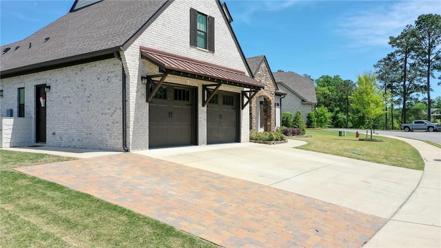 view of home's exterior featuring a lawn and a garage