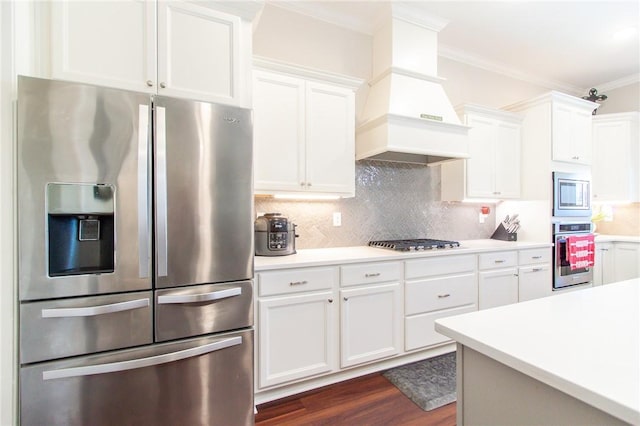 kitchen with decorative backsplash, stainless steel appliances, and white cabinetry