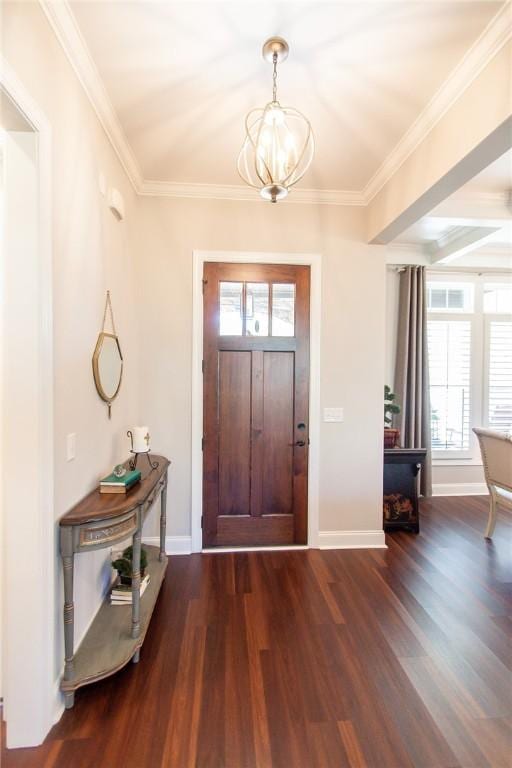 entrance foyer with dark wood-type flooring, a wealth of natural light, ornamental molding, and a notable chandelier