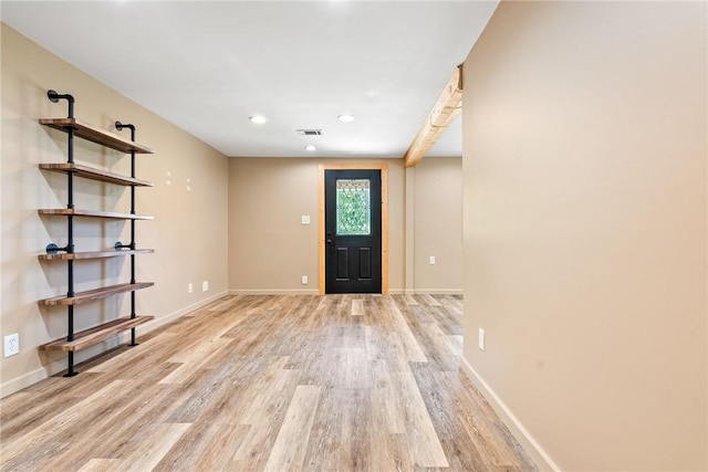 entryway with light wood-style floors, baseboards, and recessed lighting