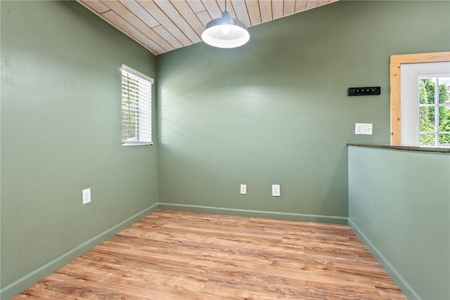 unfurnished room with baseboards, light wood finished floors, wood ceiling, and lofted ceiling