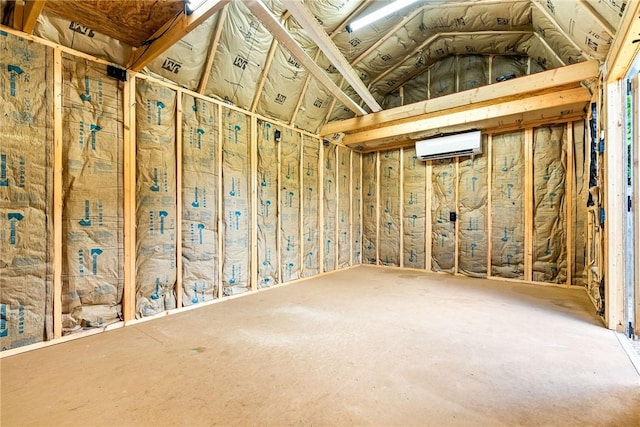 misc room featuring a wall mounted air conditioner and lofted ceiling