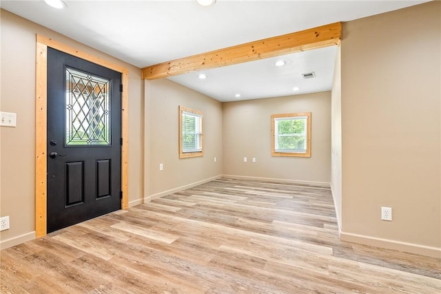 foyer entrance with light wood finished floors, recessed lighting, baseboards, and beamed ceiling