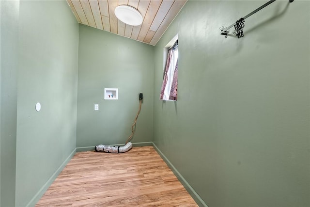 clothes washing area featuring washer hookup, light wood-style flooring, and baseboards