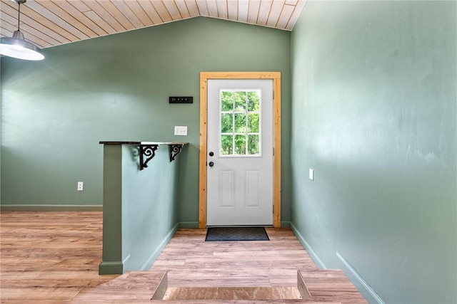 doorway featuring wood finished floors, vaulted ceiling, baseboards, and wood ceiling