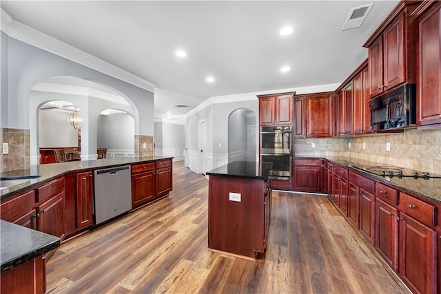 151 Landing Way, Smiths Station, AL 36877 - kitchen with black appliances, dark brown cabinets, crown molding, arched walkways, and a wainscoted wall