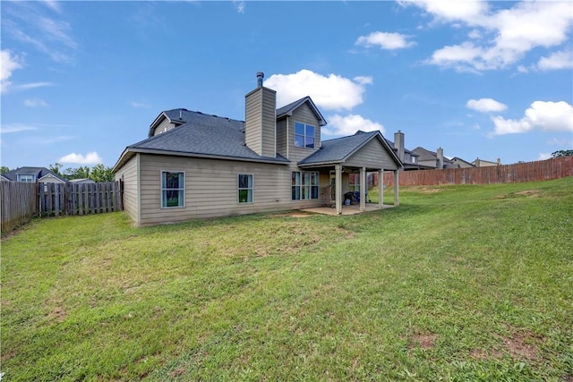151 Landing Way, Smiths Station, AL 36877 - back of property with a patio area, a fenced backyard, a chimney, and a shingled roof