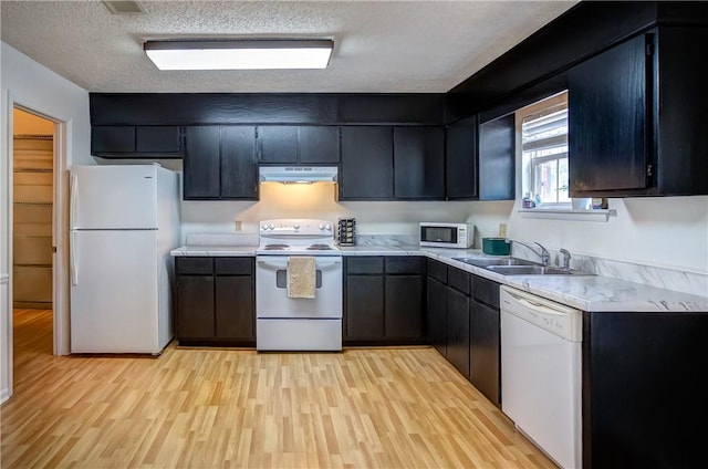 162 E University Dr Unit I201, Auburn, AL 36832 - kitchen featuring white appliances, under cabinet range hood, light countertops, light wood-style floors, and a textured ceiling