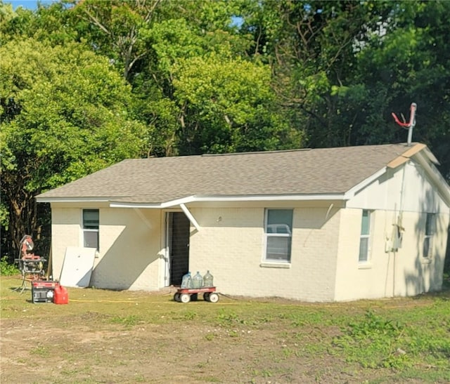 314 E Rosa Park, Tuskegee, AL 36083 - view of front facade with a front lawn and roof with shingles