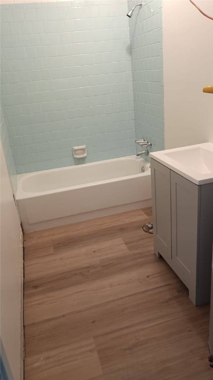 314 E Rosa Park, Tuskegee, AL 36083 - full bath with vanity, wood finished floors, and shower / bathtub combination