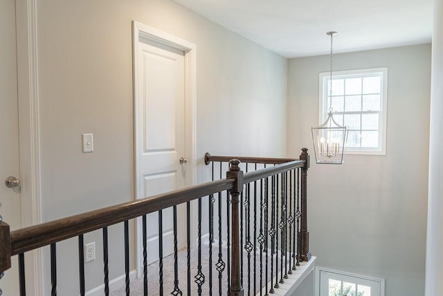 hall featuring an inviting chandelier