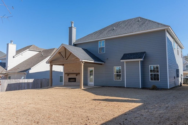 back of house featuring a patio and a fireplace