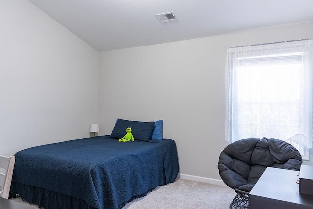 bedroom featuring light carpet