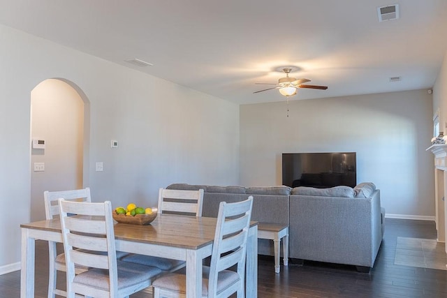 dining space with ceiling fan and dark hardwood / wood-style floors