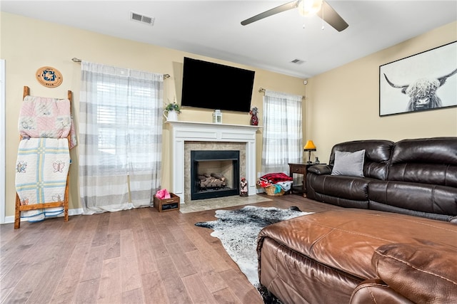 2655 Anderson Ct, Auburn, AL 36832 - living area with wood finished floors, a ceiling fan, and a tiled fireplace