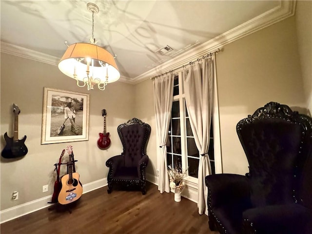 living area featuring ornamental molding, baseboards, a chandelier, and wood finished floors