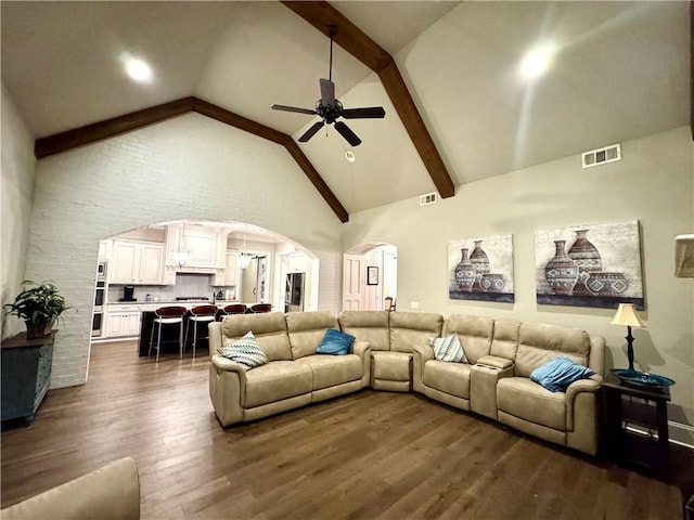 living room featuring dark wood-style flooring, visible vents, ceiling fan, high vaulted ceiling, and arched walkways