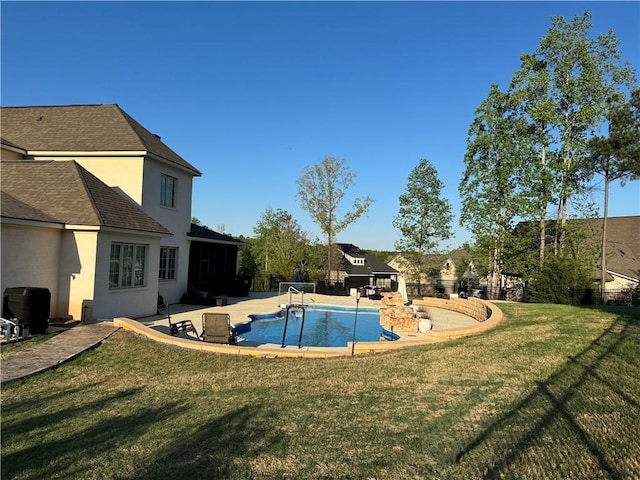 pool featuring a patio and a yard
