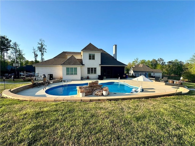 view of pool featuring a patio, a yard, and fence
