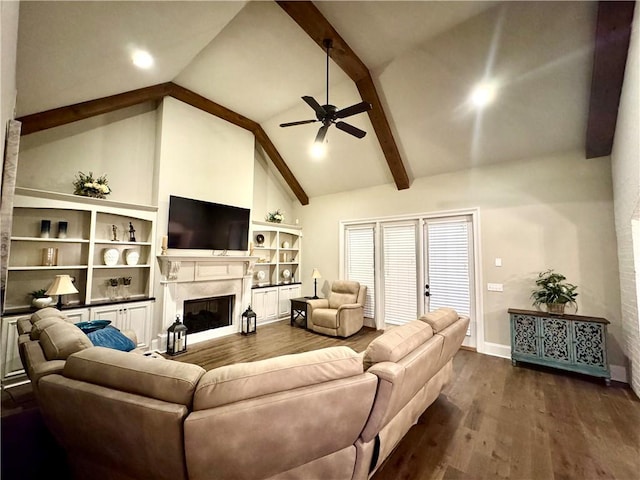 living room featuring a premium fireplace, ceiling fan, beamed ceiling, and dark wood-style floors
