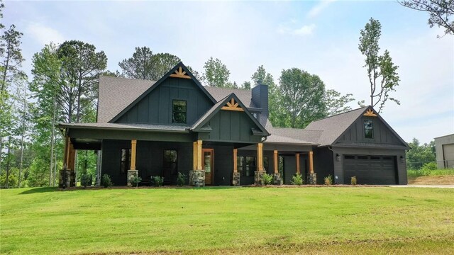 craftsman inspired home featuring a chimney, board and batten siding, covered porch, a garage, and a front lawn