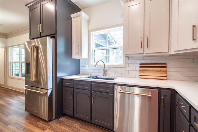 kitchen with stainless steel appliances, light countertops, and a sink