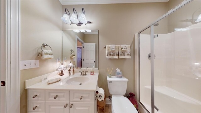 bathroom featuring vanity, toilet, and a shower with door