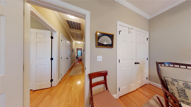 hall with hardwood / wood-style floors and crown molding