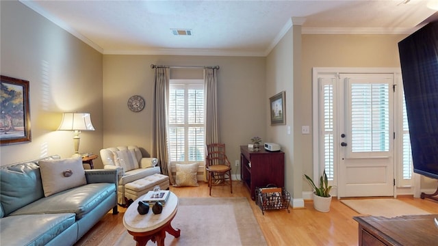 living room featuring crown molding and hardwood / wood-style floors