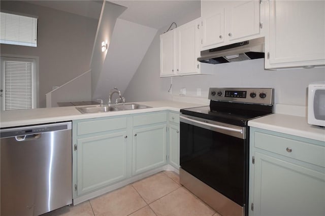 kitchen with stainless steel appliances, under cabinet range hood, a sink, light tile patterned floors, and light countertops
