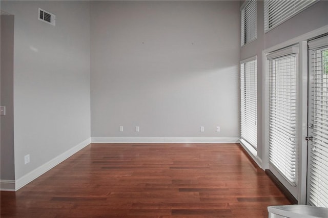 unfurnished room featuring wood finished floors and baseboards