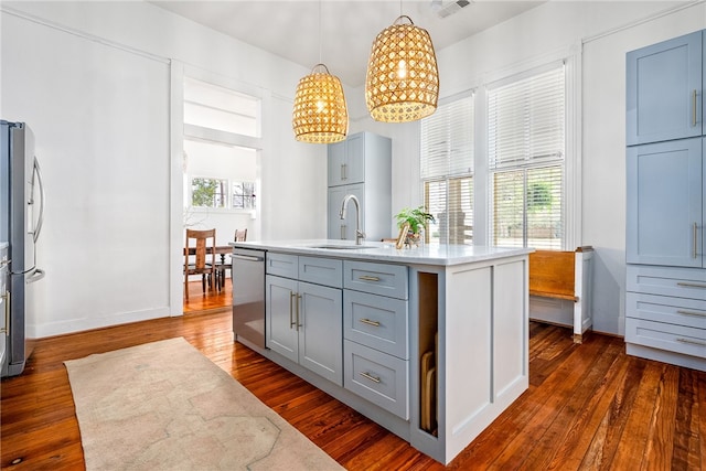 kitchen with appliances with stainless steel finishes, plenty of natural light, and dark wood finished floors