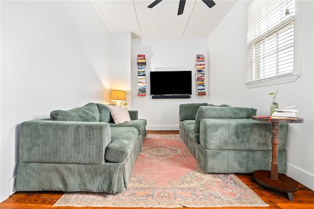 living area featuring ceiling fan, baseboards, and wood finished floors