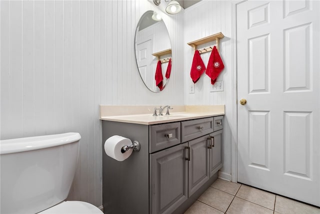 bathroom with vanity, tile patterned floors, and toilet